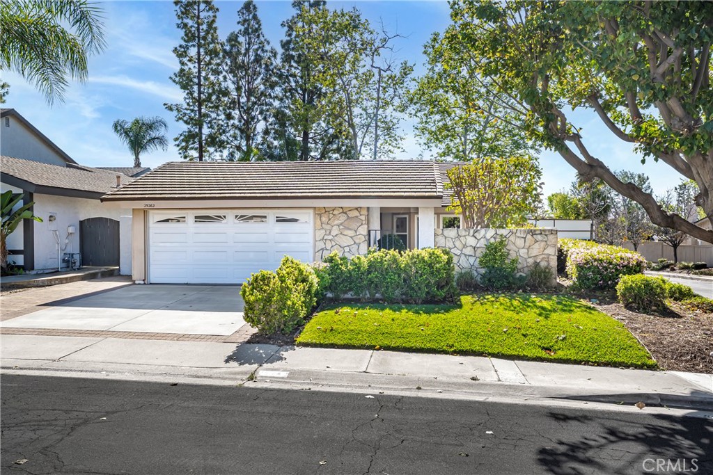 Charming single-story home with stone accents, a two-car garage, and a beautifully maintained front yard. - 25262 Aldea Court, Mission Viejo CA 92691 - photo 1