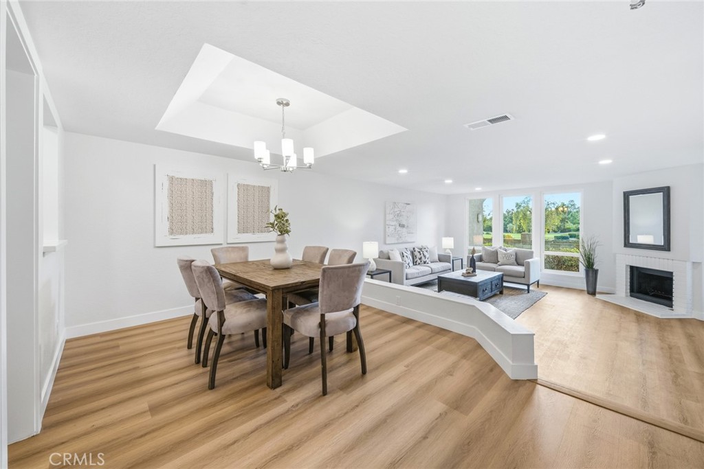 Dining area with a view into the living room and fireplace. - 25911 Blascos 102, Mission Viejo CA 92691 - photo 11