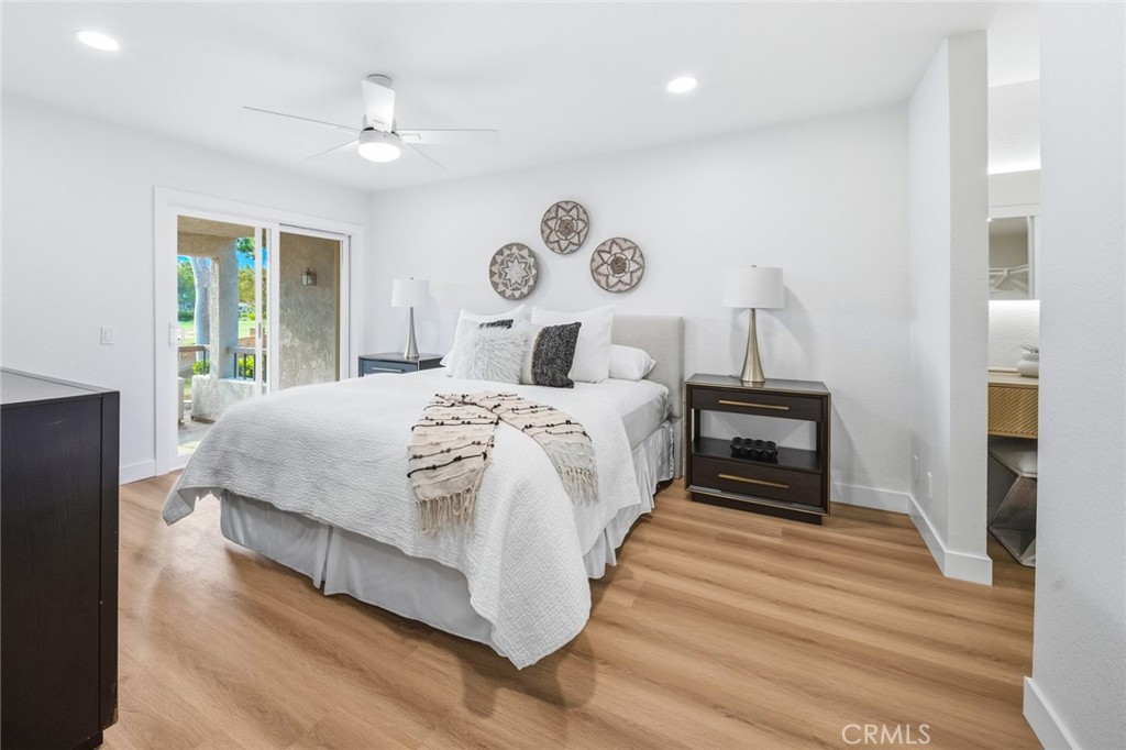 Bedroom with ceiling fan and windows to the outdoors. - 25911 Blascos 102, Mission Viejo CA 92691 - photo 19
