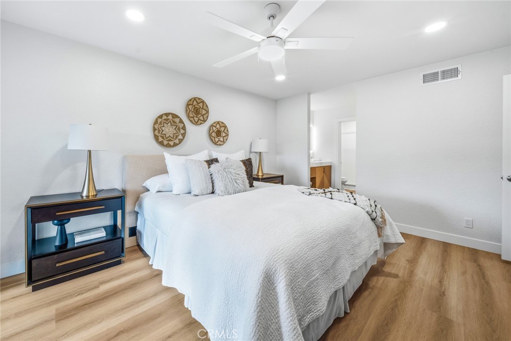 Bedroom with ceiling fan and bedside tables. - 25911 Blascos 102, Mission Viejo CA 92691 - photo 21