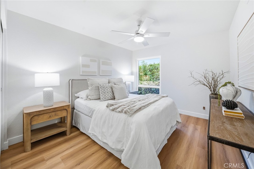 Bedroom with ceiling fan, nightstand and window. - 25911 Blascos 102, Mission Viejo CA 92691 - photo 25