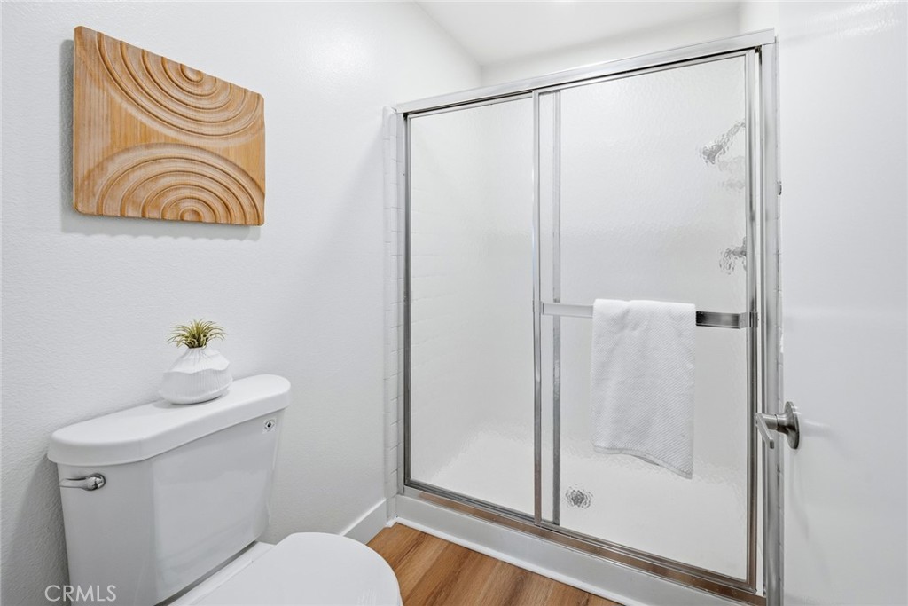 Bathroom with glass-door stall shower and toilet. - 25911 Blascos 102, Mission Viejo CA 92691 - photo 29
