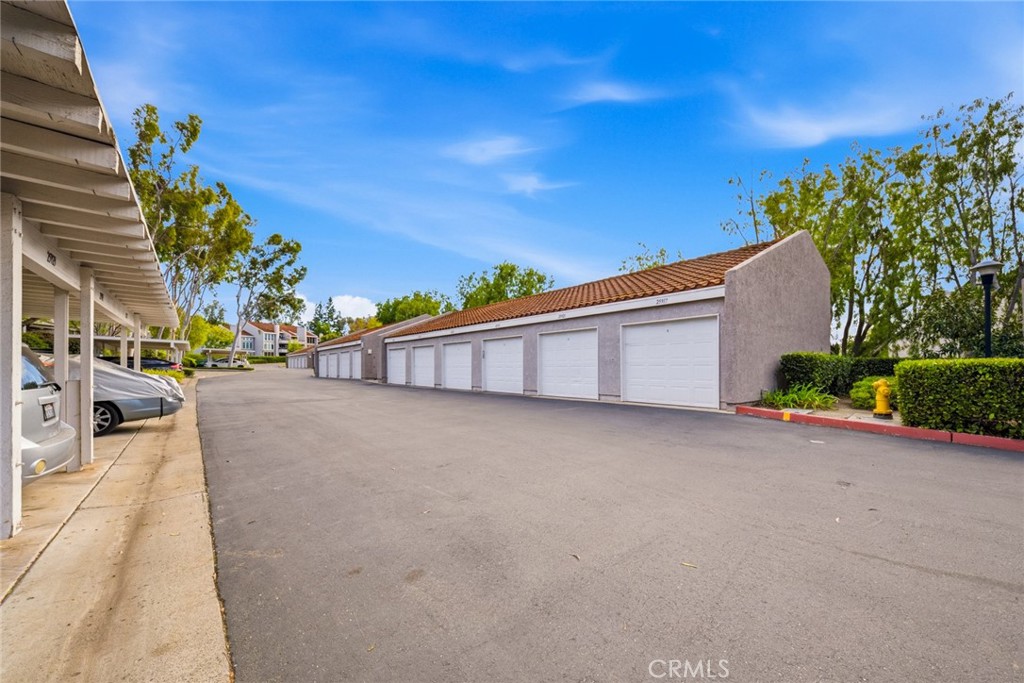 Community driveway with detached garages. - 25911 Blascos 102, Mission Viejo CA 92691 - photo 34