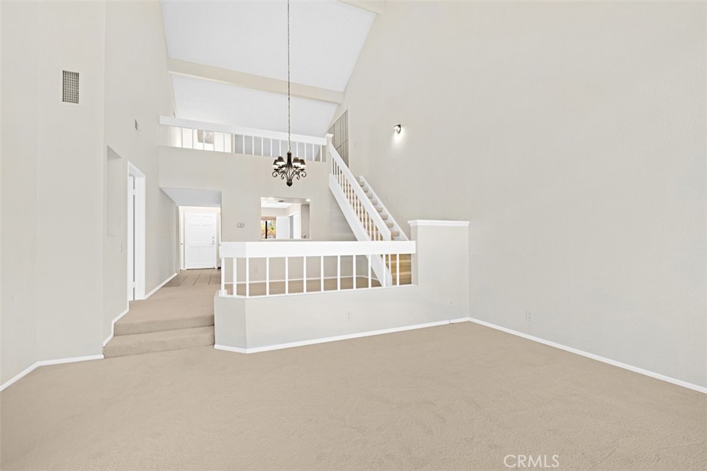 living room original looking toward front door, kit , dining with stairs to loft - 25915 Orbita, Mission Viejo CA 92691 - photo 6