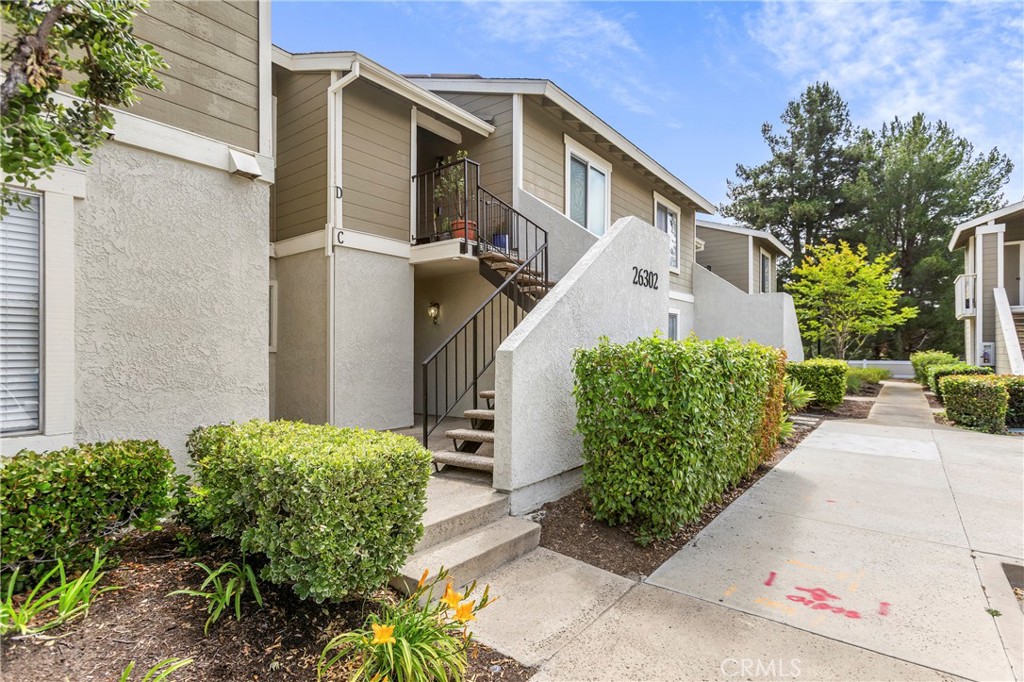 Building front, unit is on bottom floor. - 26302 Los Viveros 151C, Mission Viejo CA 92691 - photo 1