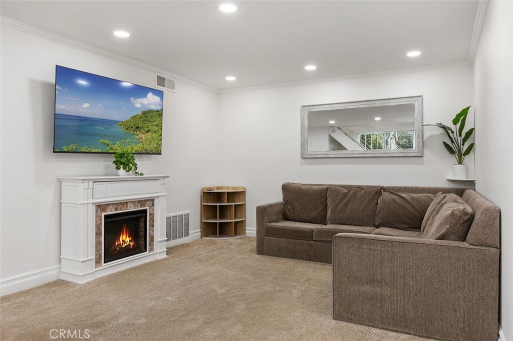 Living Room virtually staged with TV picture and flames in fireplace. - 26495 Via Damasco, Mission Viejo CA 92691 - photo 5