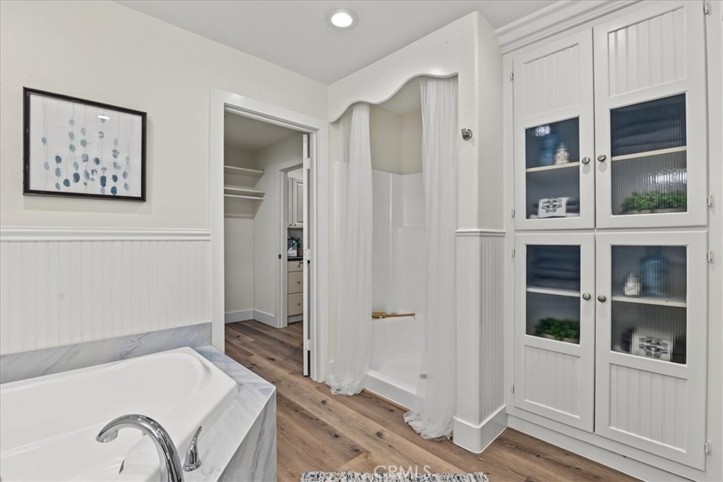 Featuring the adjoining Primary Walk-in Closet, Shower Stall, and Built-in Storage with Decorative Glass Shelving. - 26515 Via Del Sol, Mission Viejo CA 92691 - photo 41
