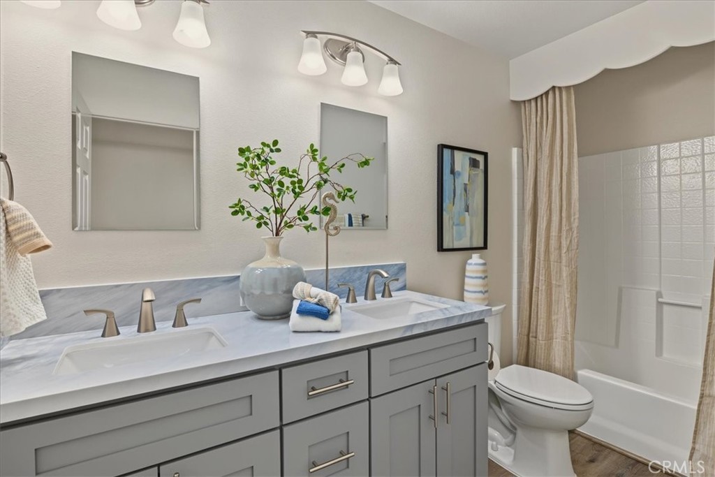 Upstairs Hall Full Bathroom with Double-Sink Vanity and ample Cabinetry. - 26515 Via Del Sol, Mission Viejo CA 92691 - photo 49