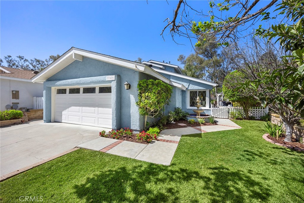 Here’s the home you’ve been waiting for—featuring a manicured lawn, lush landscaping, and a welcoming walkway that leads - 27426 Sereno, Mission Viejo CA 92691 - photo 1