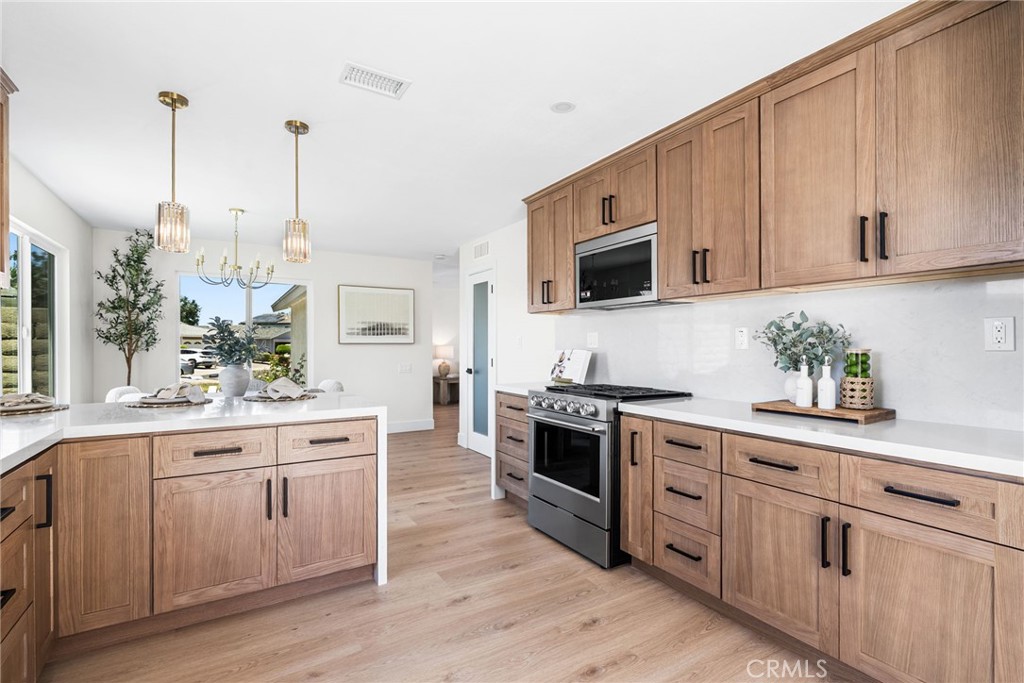 Designed for everyday living, this open kitchen seamlessly connects to the dining area. - 27616 Soltero, Mission Viejo CA 92691 - photo 1