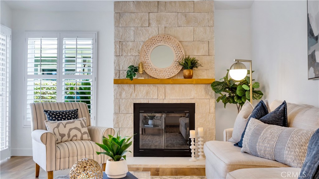 Living room feature with stone accented fireplace and natural light. - 27843 Espinoza, Mission Viejo CA 92692 - photo 1