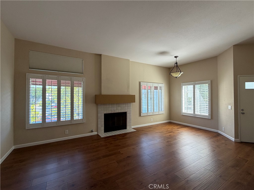 Living room featuring fireplace and dining area. - 27853 Ruby, Mission Viejo CA 92691 - photo 3