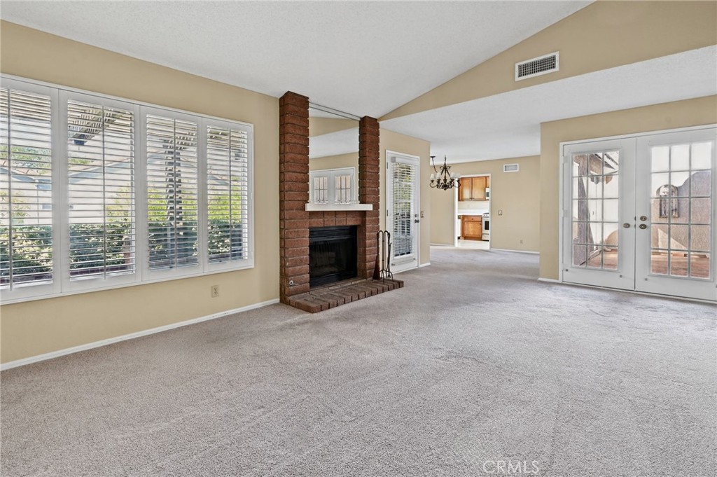 Living room with French door to back patio and French doors to the enclosed atrium style patio - 28546 Cano, Mission Viejo CA 92692 - photo 7