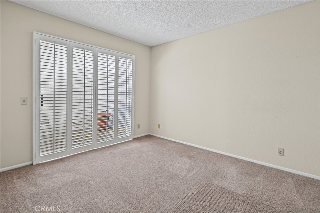 Large secondary bedroom with sliding door out to another side patio area - 28546 Cano, Mission Viejo CA 92692 - photo 17