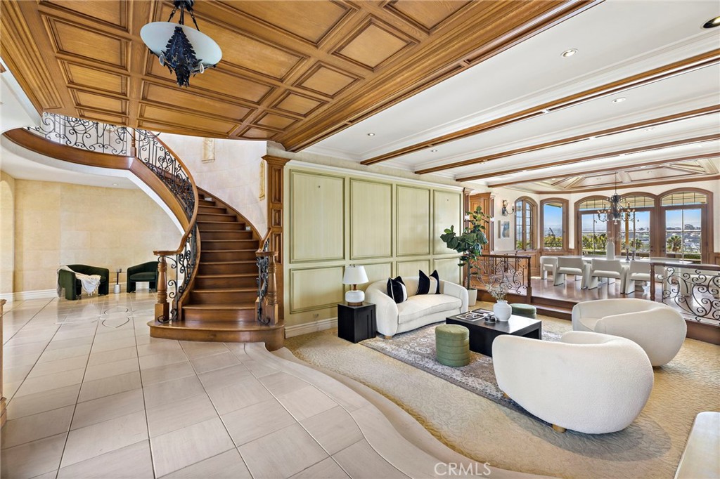 Large oak staircase and living room - 108 Kings Place, Newport Beach CA 92663 - photo 9