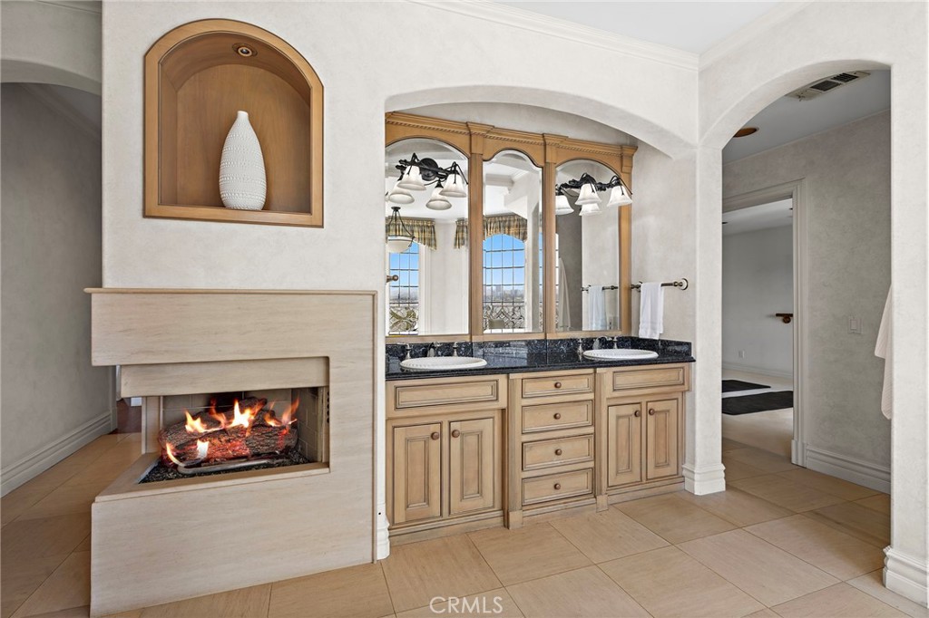 Fireplace in the main bathroom - 108 Kings Place, Newport Beach CA 92663 - photo 34