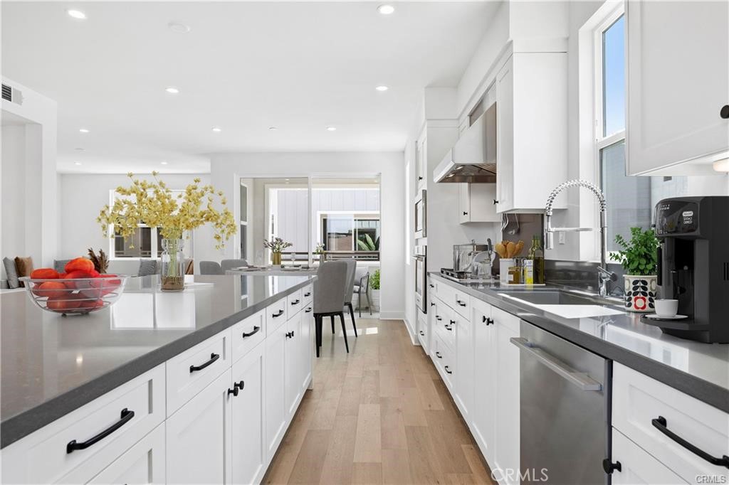 A view of the kitchen & dining area, then there is an outside covered patio just beyond the sliding glass doors. - 1171 Winslow Lane, Newport Beach CA 92660 - photo 4