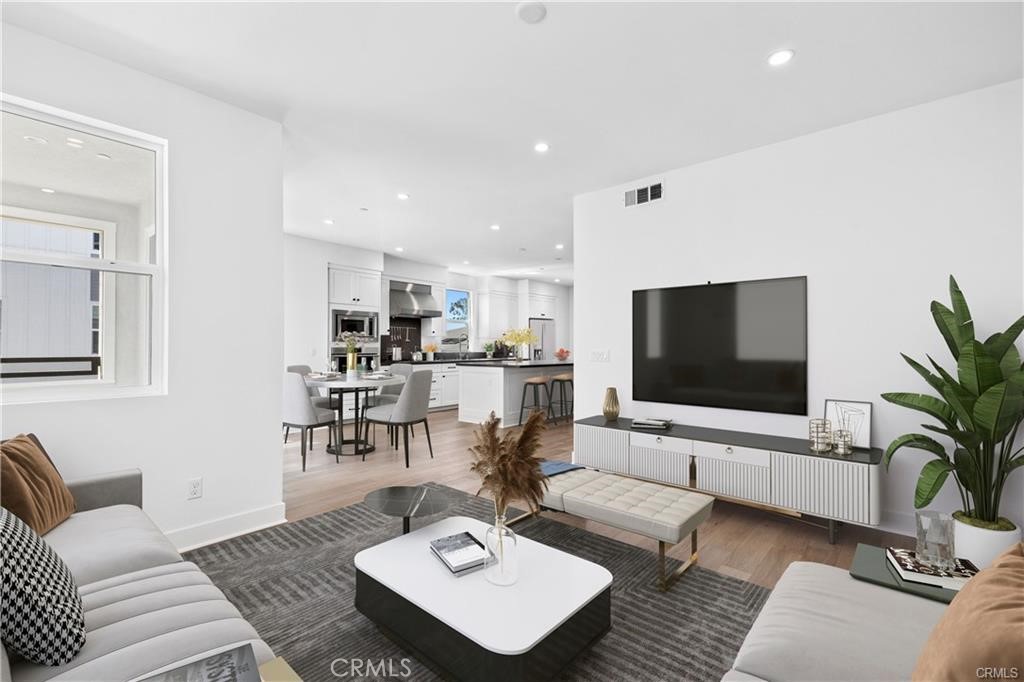 This view is looking from the living room back to the kitchen and dining area. - 1171 Winslow Lane, Newport Beach CA 92660 - photo 8