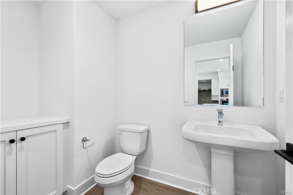 Powder room is located off the kitchen & living room. - 1171 Winslow Lane, Newport Beach CA 92660 - photo 9