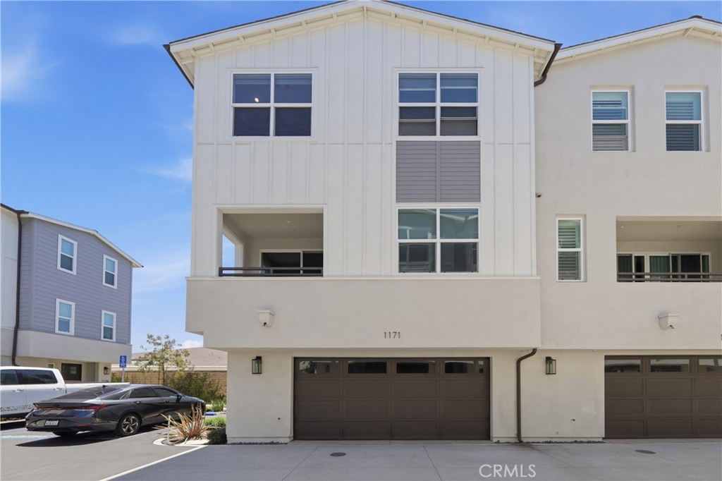 There is an attached two car garage and right above if the spacious outdoor patio. - 1171 Winslow Lane, Newport Beach CA 92660 - photo 20