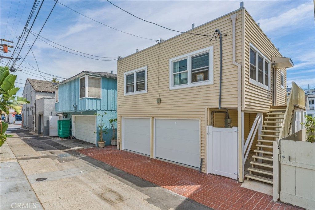 Rear of home with 2-car garages and steps to Rear Unit - 121 Marine Avenue, Newport Beach CA 92662 - photo 17