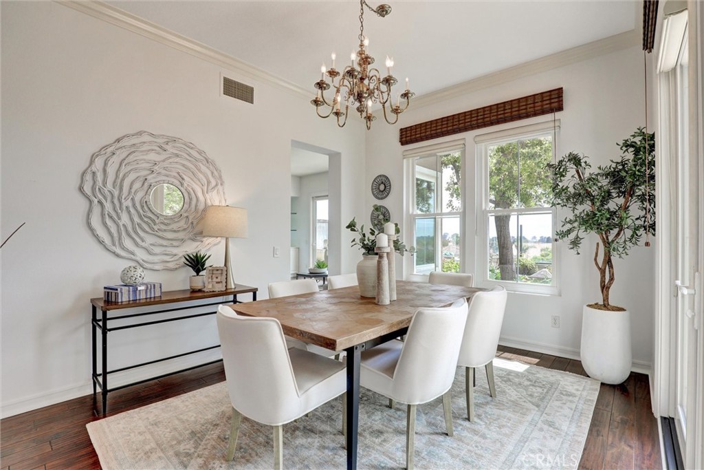 An elegant dining room with panoramic coastal views as the backdrop. - 1402 Sea Ridge Drive, Newport Beach CA 92660 - photo 13