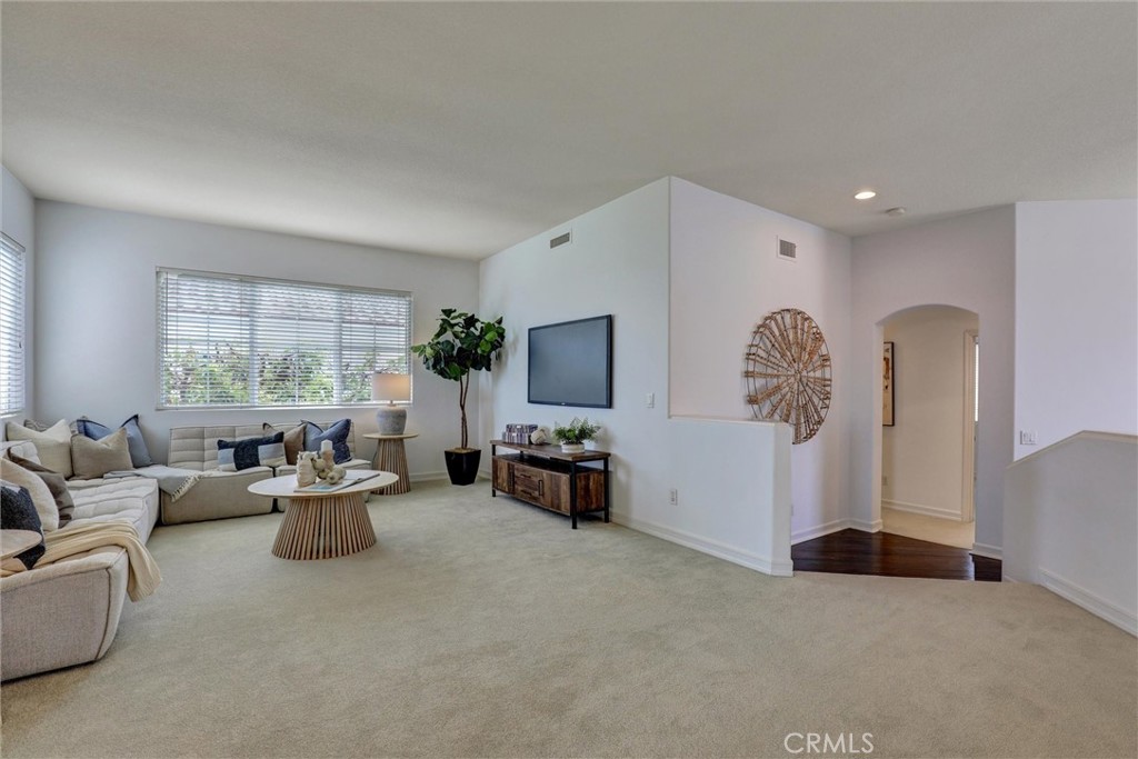 The spacious upstairs loft provides a versatile living area ideal for a family room, home office, or media space. - 1402 Sea Ridge Drive, Newport Beach CA 92660 - photo 18