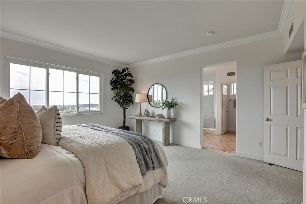 The primary suite offers generous proportions, a walk-in closet, and a well-appointed ensuite bathroom. - 1402 Sea Ridge Drive, Newport Beach CA 92660 - photo 21