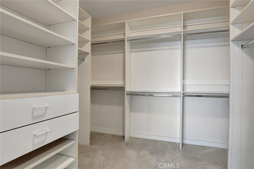 A thoughtfully designed walk-in closet features extensive built-in storage and organization. - 1402 Sea Ridge Drive, Newport Beach CA 92660 - photo 23
