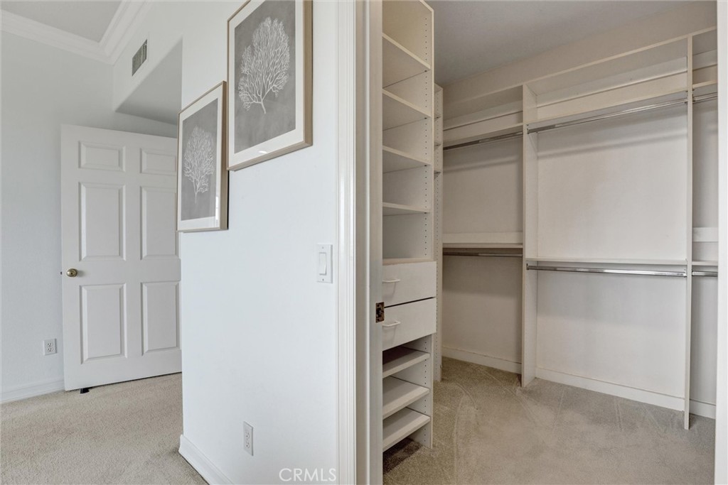 The expansive walk-in closet combines exceptional storage with custom built-in organization. - 1402 Sea Ridge Drive, Newport Beach CA 92660 - photo 24