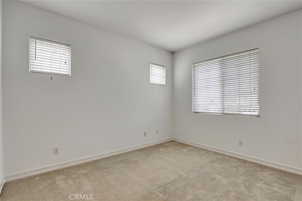 Bright and comfortable, this secondary bedroom offers a welcoming space for family or overnight guests. - 1402 Sea Ridge Drive, Newport Beach CA 92660 - photo 32