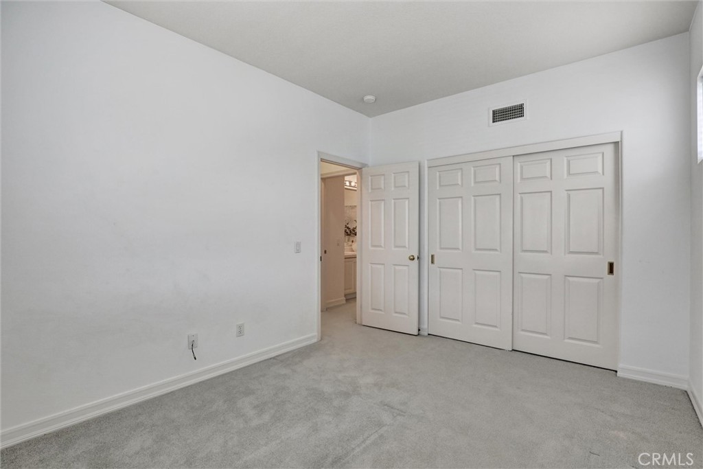 This inviting secondary bedroom is filled with natural light and offers comfortable accommodations for family or guests. - 1402 Sea Ridge Drive, Newport Beach CA 92660 - photo 33