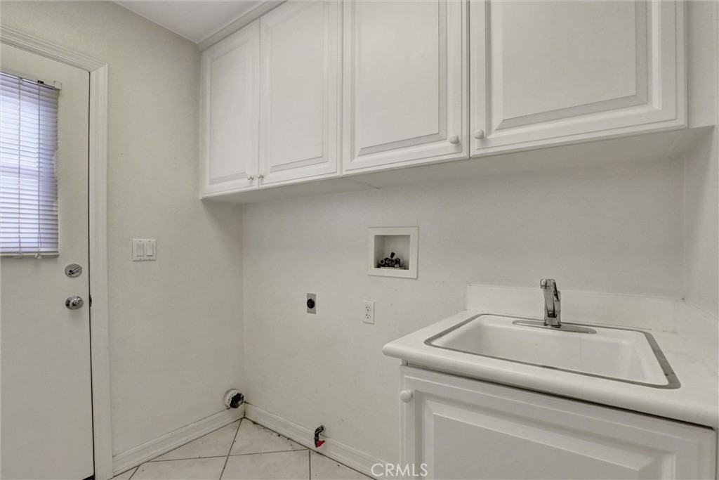 The separate interior laundry room offers built-in cabinetry along with both gas and electric dryer hookups for added fl - 1402 Sea Ridge Drive, Newport Beach CA 92660 - photo 35