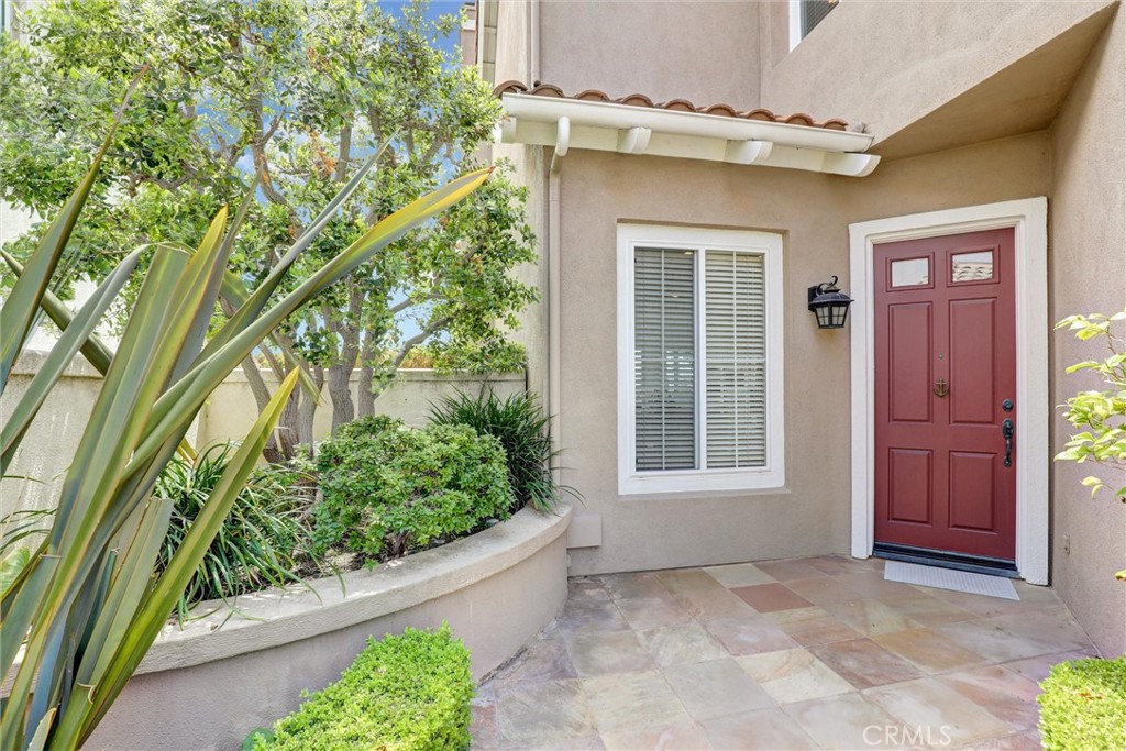 A welcoming covered entry with stone flooring, mature landscaping, and a private front porch creates an inviting first i - 1402 Sea Ridge Drive, Newport Beach CA 92660 - photo 39