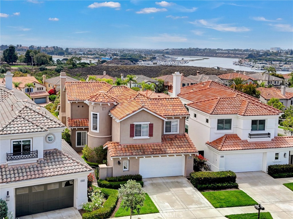 An elevated aerial view highlights the home's commanding position above Newport Back Bay, where coastal, bay, and city l - 1402 Sea Ridge Drive, Newport Beach CA 92660 - photo 42