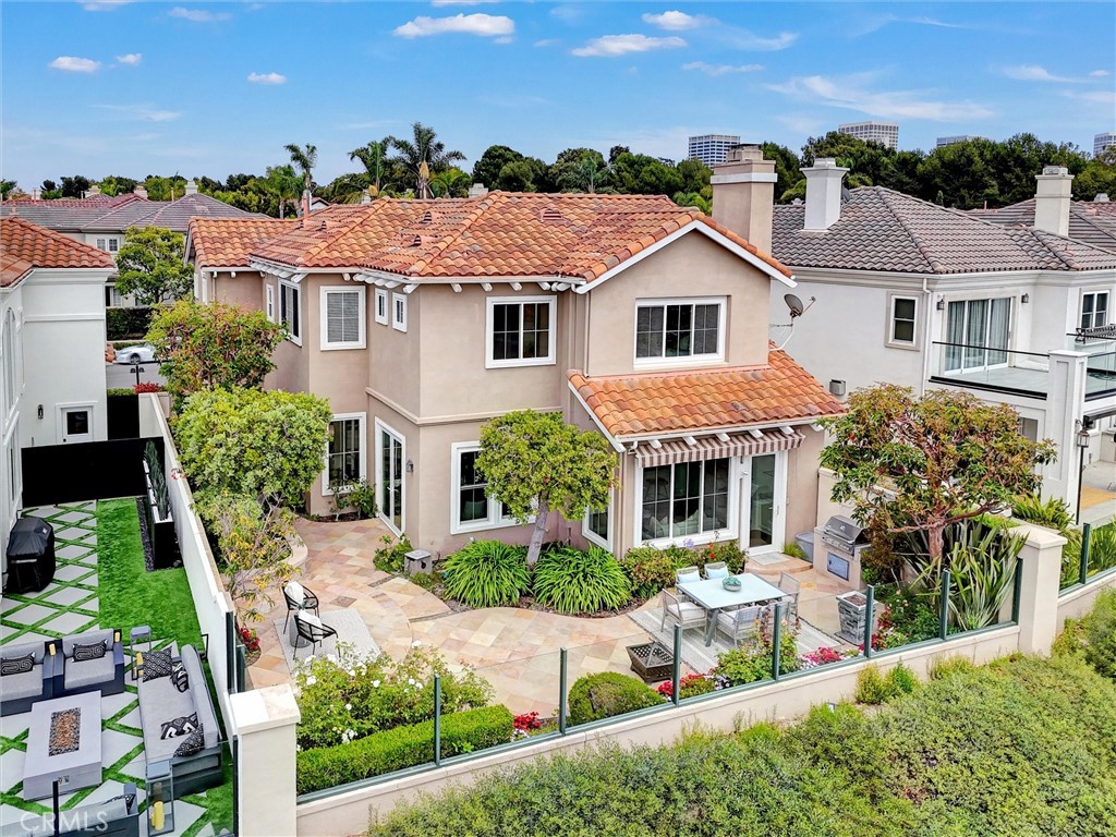 The beautifully landscaped rear yard offers multiple seating areas and seamless indoor-outdoor living along the scenic b - 1402 Sea Ridge Drive, Newport Beach CA 92660 - photo 45