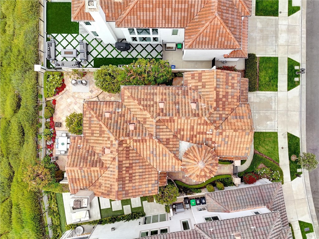 An overhead perspective showcases the home's distinctive rooflines, turret, and thoughtfully designed outdoor living spa - 1402 Sea Ridge Drive, Newport Beach CA 92660 - photo 46