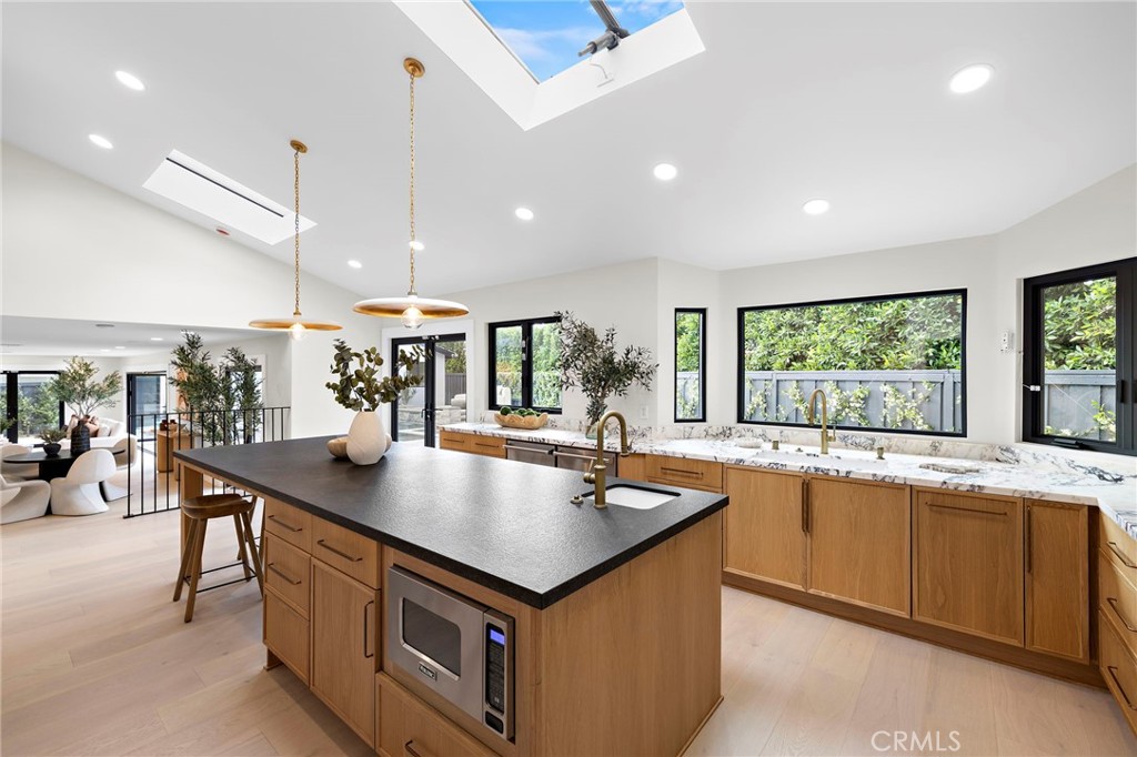 Brightly lit kitchen with ample windows and an automatic skylight window - 1700 Port Ashley, Newport Beach CA 92660 - photo 14