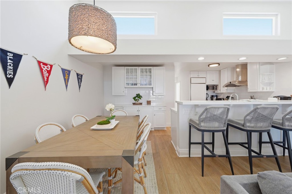 Unit A: Dining area with local surfspot flags - 2202 W Oceanfront, Newport Beach CA 92663 - photo 4