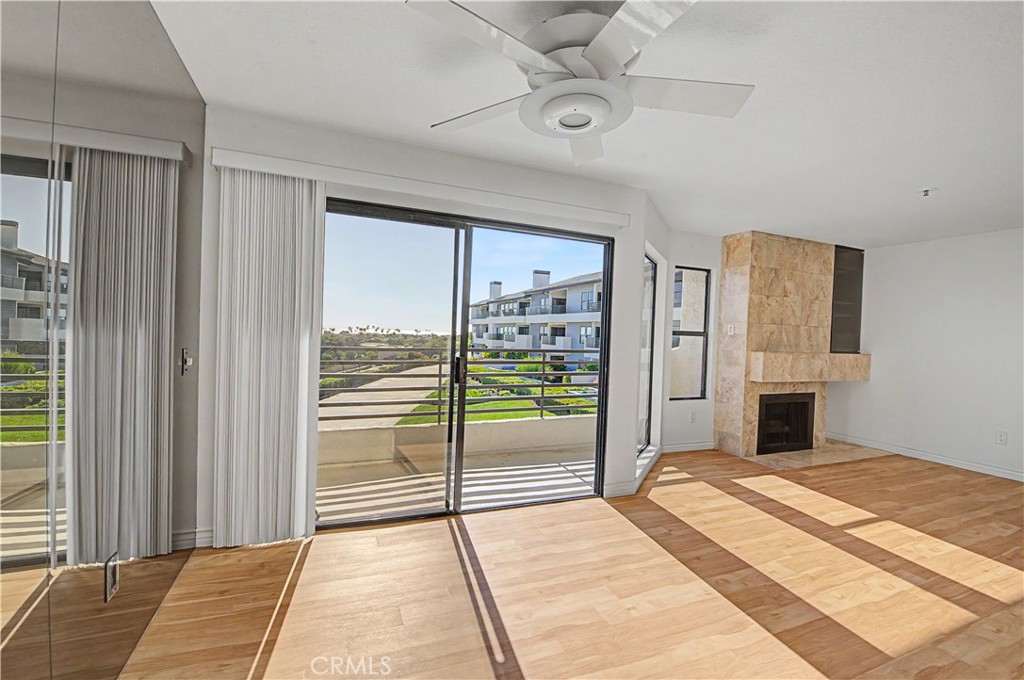 Ocean view living room with gas fireplace. - 280 Cagney Lane 207, Newport Beach CA 92663 - photo 4