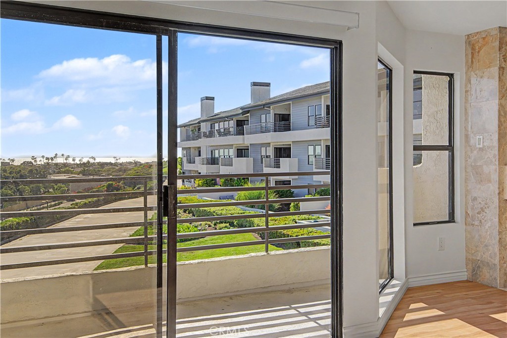 Balcony off living room includes a gas hookup for your barbeque. - 280 Cagney Lane 207, Newport Beach CA 92663 - photo 6