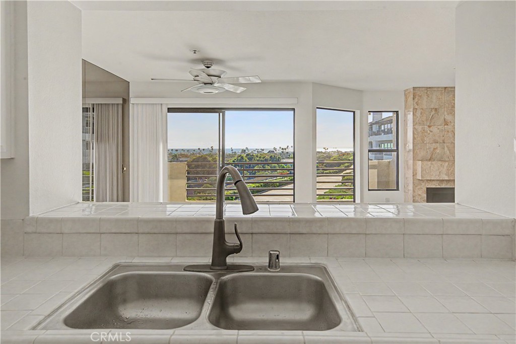 View from kitchen. Prep dinner with the ocean in the distance. - 280 Cagney Lane 207, Newport Beach CA 92663 - photo 8