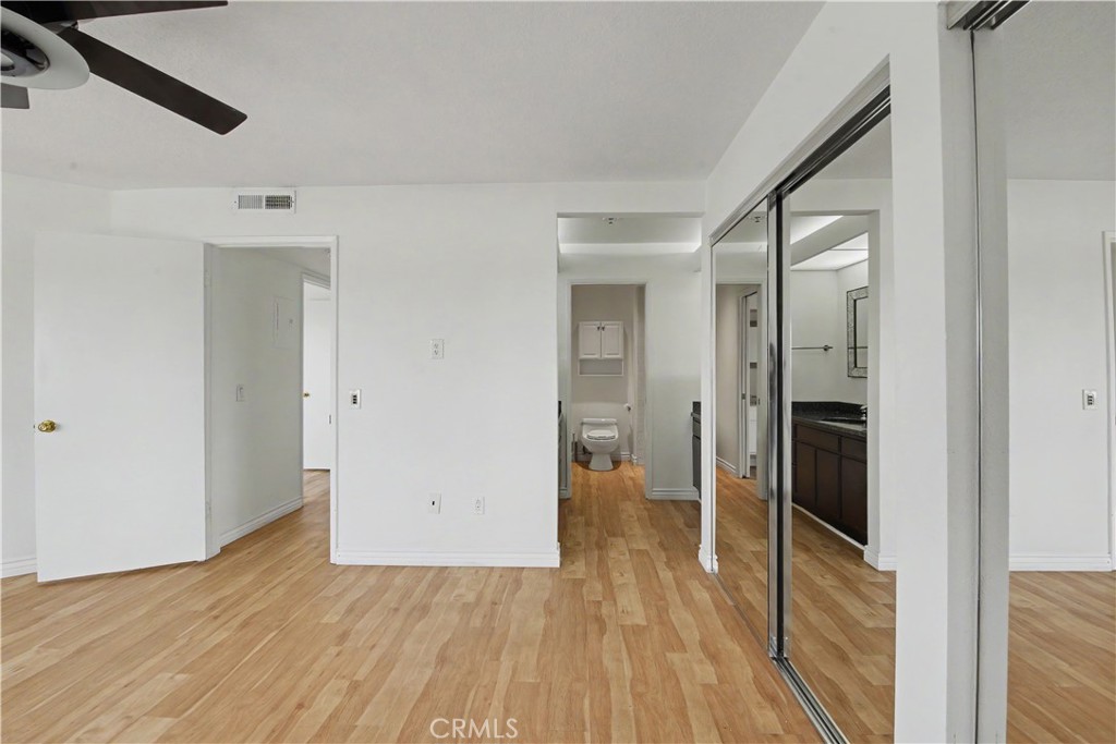 Mirrored closets feature custom California Closet storage. - 280 Cagney Lane 207, Newport Beach CA 92663 - photo 16