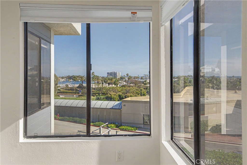 Double-door second bedroom looks to ocean and harbor and also make a great home office. - 280 Cagney Lane 207, Newport Beach CA 92663 - photo 18