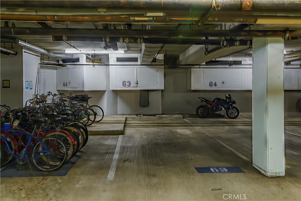 Unit 207's spaces are conveniently right by the elevator. Storage locker above the tandem spaces. - 280 Cagney Lane 207, Newport Beach CA 92663 - photo 49