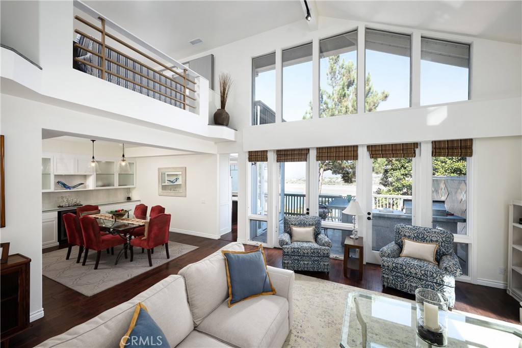 Living & Dining Areas: Soaring ceilings and expansive windows fill the open living and dining areas with natural light w - 36 Vienna, Newport Beach CA 92660 - photo 3
