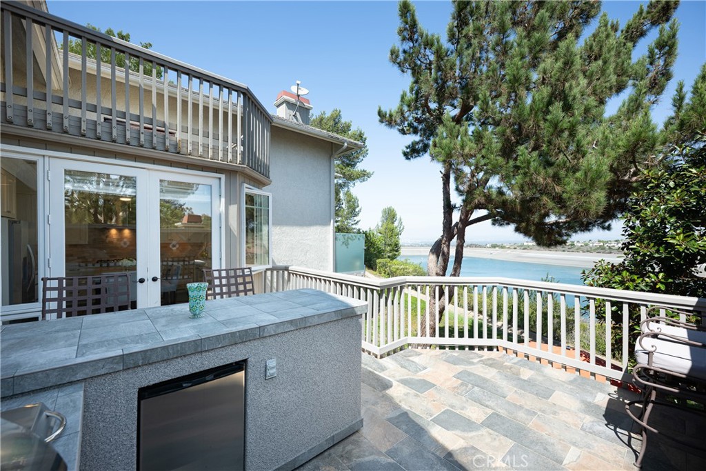 View Deck: Elevated deck combines outdoor living with a built-in counter area and direct access to the kitchen. Mature t - 36 Vienna, Newport Beach CA 92660 - photo 11
