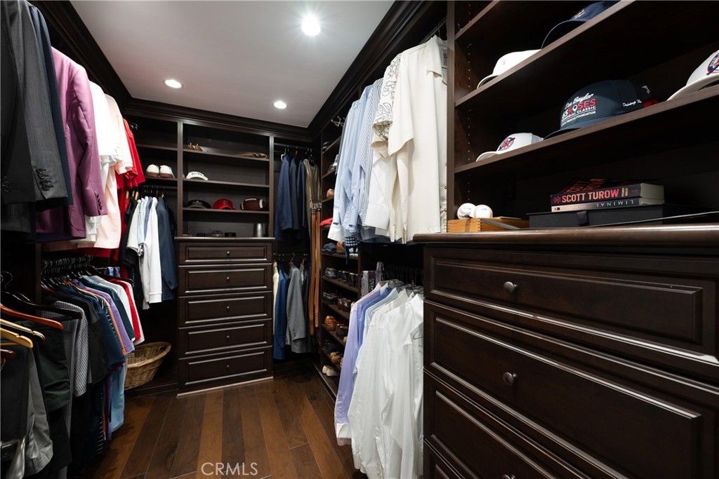 Walk-In Closet: Custom walk-in closet offers extensive built-in shelving, hanging space, drawers, and dedicated storage, - 36 Vienna, Newport Beach CA 92660 - photo 18