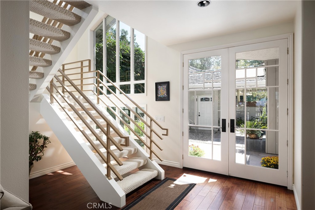 Staircase & Courtyard Access: Light-filled staircase features contemporary railings and a dramatic wall of windows overl - 36 Vienna, Newport Beach CA 92660 - photo 22