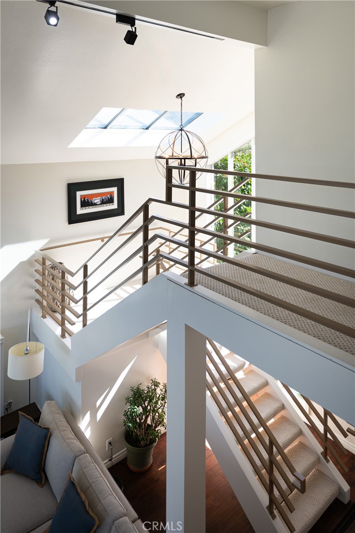 Staircase & Upper Landing: Open upper landing overlooks the main living area and showcases the home’s multi-level design - 36 Vienna, Newport Beach CA 92660 - photo 23